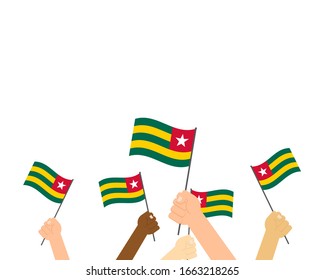 Vector illustration of hands holding Togo flags on white background