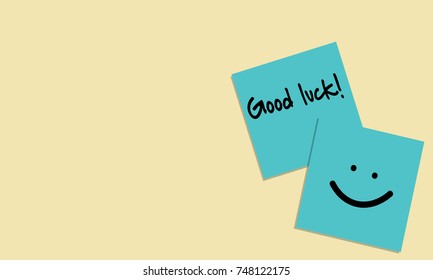 Vector illustration of handwriting of message "Good luck!" and smile face on blue sticky note on yellow background. Vector illustration background.