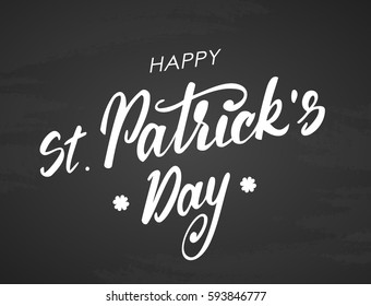 Vector illustration: Handwritten modern brush lettering of Happy St. Patrick's Day on blackboard background. 