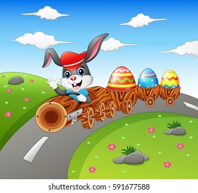 Vector illustration of Happy easter bunny driving a timber train carrying Easter eggs