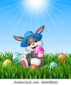 Vector illustration of Happy easter bunny wearing a hat carrying easter eggs in the grass