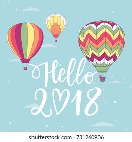 Vector illustration, Hello 2018 hand drawn lettering on a sky background wit retro hot air balloons
