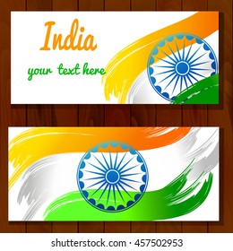 Vector illustration for the India Independence Day. 2 Greeting cards for celebration of India Independence Dayin made of yellow green white Indian Flag colors with Ashoka Wheels on a wood background