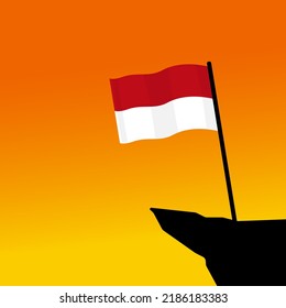 Ilustración vectorial de la bandera indonesia ondeando al borde de un acantilado en la tarde. Concepto del Día de la Independencia de Indonesia.