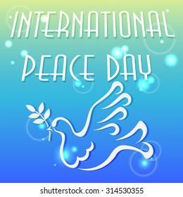 Vector illustration for the international day of peace with a dove and olive branch on blue background