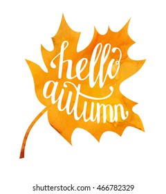 Vector illustration of maple leaf with hand written phrase Hello autumn. Hand written slogan on bright watercolor texture isolated on white background for your poster, placard, card or flyer design.