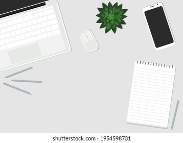 Vector illustration. On the desktop are a laptop, a mobile phone, a plant and a paper notebook. View from above