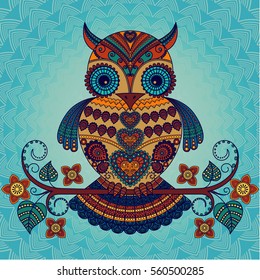 Vector illustration of an owl sitting on a branch with flowers. Bright decorative owl in the ethnic style on a blue background.