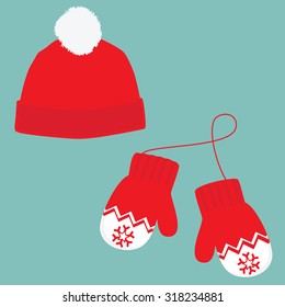 Vector illustration pair of knitted christmas mittens and red winter hat with pompom on blue background. Christmas greeting card with mittens and winter hat