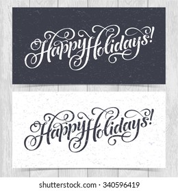 Vector illustration of paper cards with Happy Holidays lettering and ornamental elements. Christmas calligraphy on wood background.