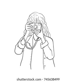 Vector illustration of pretty girl holding vintage camera and looking through viewfinder to take photograph. Outline, linear, contour, hand drawn sketch design, simple style, black and white ink.