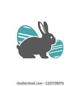 The vector illustration a rabbit sits a splitting off of two Easter eggs. Set of two vector icons. Easter symbol a rabbit and beautifully chiken eggs. Flat design Monochrome