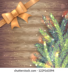 Vector illustration of realistic sparkled green and blue fir tree branch and golden silk ribbon with bow on wood background. Beautiful design for Christmas and New Year postcard and banner.