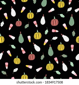 Vector illustration of repeat pattern with pears, fall leaves, halloween candy, and pumpkins on a black background.