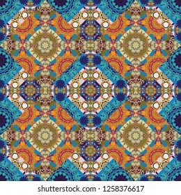 Vector illustration. With saturated shapes in blue, yellow and brown colors. Ethnic tracery for print on textile. Seamless pattern abstract background. Textile design texture.