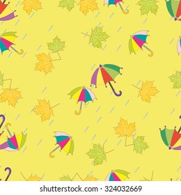 Vector illustration. Seamless ornament with autumn pictures. Image will fall: multicolored umbrella and maple leaves.