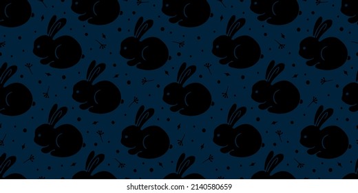 Vector illustration. Seamless pattern with black silhouettes of rabbits, hearts and dots isolated on dark blue. Happy Easter theme. Hand drawn doodle clipart. For gift wrap, print, fabric, textile