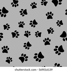 Vector illustration of a seamless pattern of black wild animal paws on a gray background