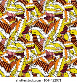 Vector illustration. Seamless pattern of cupcakes on a white, yellow and orange background. Wrapping paper.