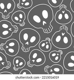 Vector illustration. Seamless pattern of large and small human skulls, hand drawn. Repetitive wallpaper of bones. Creepy evil Halloween background. The day of the Dead. Design of wrapping, gift paper.