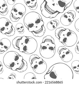 Vector illustration. Seamless pattern of large and small human skulls, hand drawn. Repetitive wallpaper of bones. Creepy evil Halloween background. The day of the Dead. Design of wrapping, gift paper.