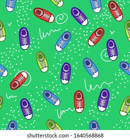 Vector illustration. The seamless pattern with light green, blue, red sport shoes on green color background. The sneakers with white lacing, simplified top view.