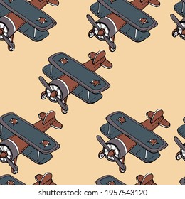 vector illustration seamless pattern retro biplane in blue and red on a pale pink background,for children wallpaper and fabric