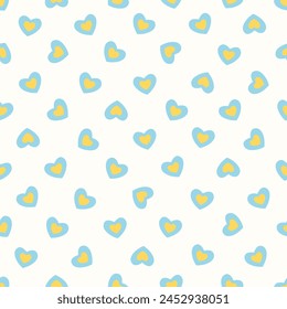 Vector illustration. Seamless pattern of small yellow-blue hearts on a light milky white background. Textile printing, fabric design, packaging, wrapping paper, children's wallpaper