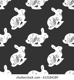 Vector illustration of seamless pattern with white rabbits isolated on dark grey background. Chalk hand drawing imitation.