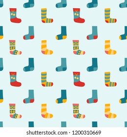 Vector illustration: seamless pattern with winter clothes: blue, red and yellow socks with different ornaments. Décor for Christmas fabrics, wallpapers and wrapping paper isolated on blue background
