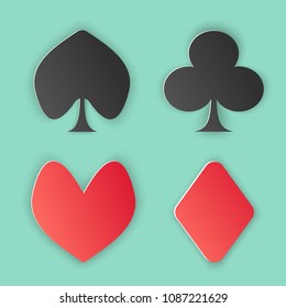 Vector illustration, set of four card suits: clubs, peaks, hearts and diamonds in papercut style with transparent shadows isolated on green background