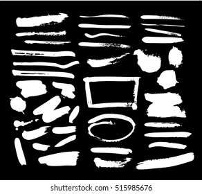 Vector illustration. Set of vector strokes. Grungy texture. White brush strokes on a black background. Collection of brushes and stains. The elements for graphic design.