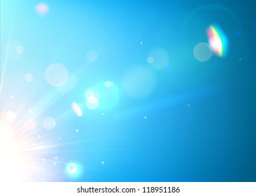 Vector illustration of soft blue abstract background with bokeh, lens flare and light streaks.
