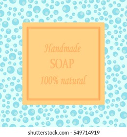 Vector illustration of a square shaped bar of soap with sample text Handmade Soap 100% Natural, with seamless background of light blue foam bubbles.