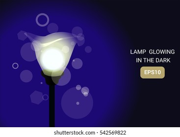 Vector illustration of a standing glowing lamp on a blue background EPS10