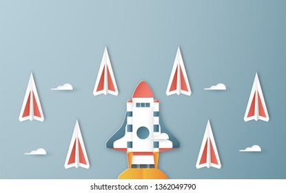 Vector illustration with Start Up concept in paper cut, craft and origami style. Rocket is on blue sky background. Template design for web banner, poster, cover, advertisement. Art craft for kid.