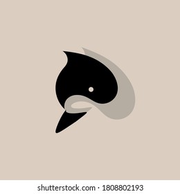 Vector illustration of a stylized killer whale fish on the background of its shadow. Logo. Flat design.
