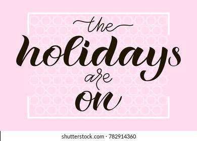 Vector illustration of "The holidays are on" calligraphy lettering poster for poster, placard, nameplate, card. Drawn art sign. Celebration hand drawn text on light pink background with white pattern