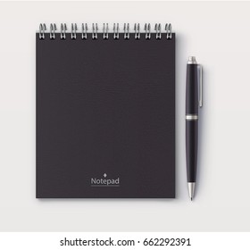 Vector illustration of top view of closed spiral black faux leather cover notebook with detailed black classic ballpoint pen on white desk background