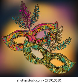 Vector illustration of two ornate floral Venetian carnival masks with feathers