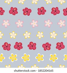 Vector illustration of various hand drawn plumeria and hibiscus tropical flowers seamless repeat pattern on a light blue background.