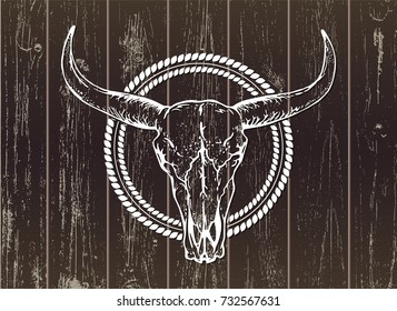 Vector illustration with a wild buffalo skull on a wooden background. White silhouette with round frame. Dark. For t-shirts, posters and other your design.