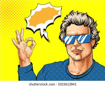 Vector illustration of young man in eyeglasses showing ok hand sign, speech bubble. Handsome man portrait in retro pop art comic style.