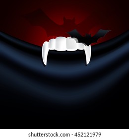 Vector illustrator of vampire teeth with bat paper on black fabric.  Halloween concept