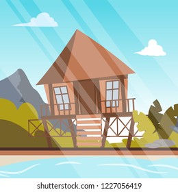 Vector image a bungalow on the shore of a lagoon. Vector illustration of a cartoon villages with bungalow buildings on the lagoon bay. The concept of life in the distance civilization the fresh air