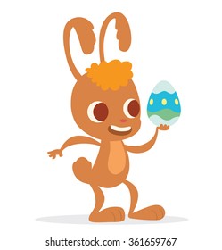 Vector image of cartoon funny light brown Easter Bunny with orange forelock with colorful Easter egg in his paw on a white background. In the theme of Easter. Vector illustration.