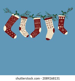 Vector image. Christmas card. Christmas socks for gifts on a garland of pine needles. Place for an inscription.