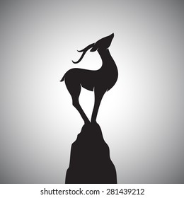 Imagen vectorial de un ciervo parado en las rocas.