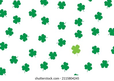 A vector image of a four-leaf clover among three-leaf clovers