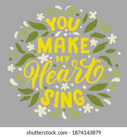 Vector image with inscription - you make my heart sing - yellow letters and leaves on a grey background. For the design of postcards, posters, banners, notebook covers, prints for t-shirt,  pillows.